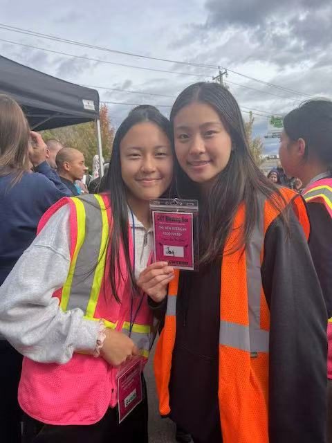 Joy and a fellow volunteer showing their pantry volunteer badges