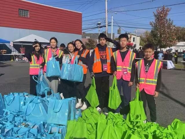 Youth volunteers in safety vests with grocery bags at the New Americans Blessing Box Food Pantry